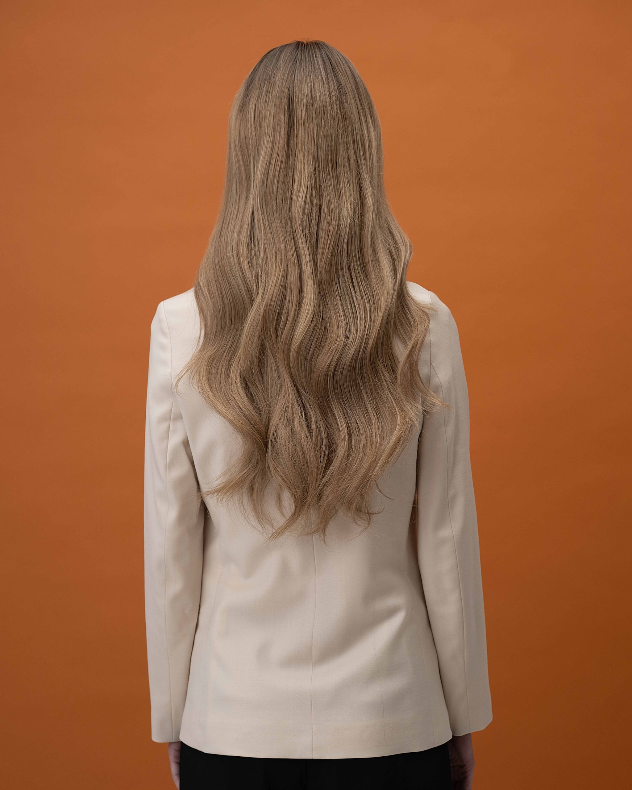 Noble Nightshade Wig 50 cm long, hand-tied Remy human hair in dark blonde that fades into soft beige blonde lengths, shown from the back to highlight the natural flow and layers