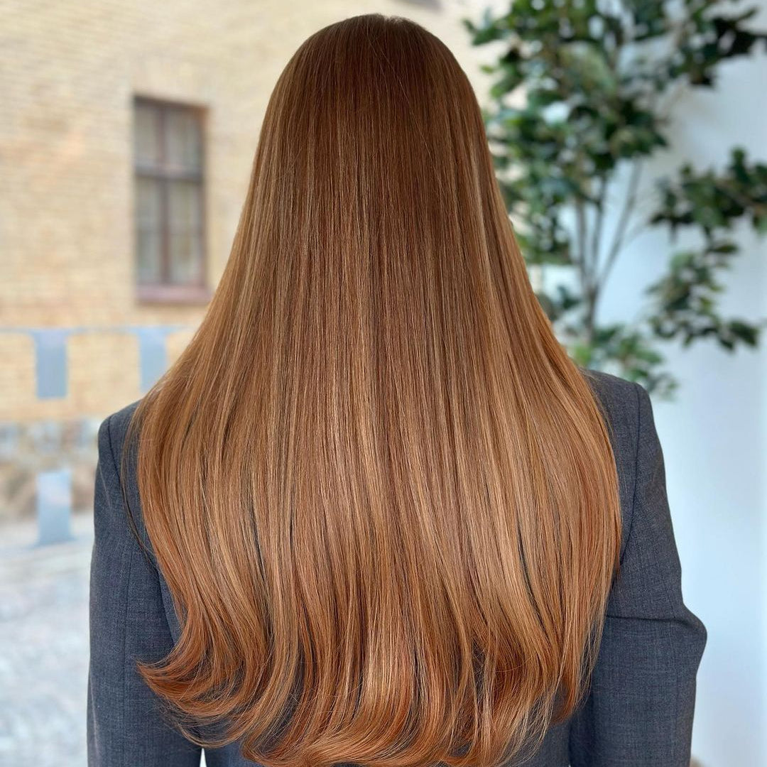 Brown-haired woman with 50cm long BHBD hair extensions.