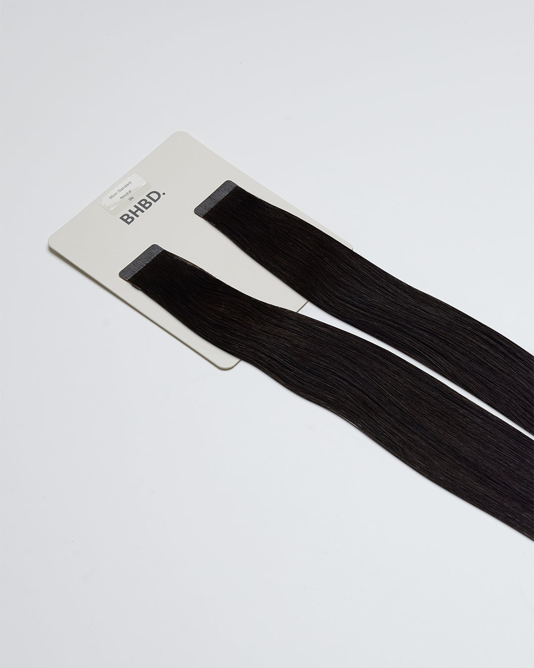 Tape Extensions 1N – pre-taped Remy human hair extensions in natural black shade; seamless, soft and tangle-free; comes in 35cm, 50cm, and 60cm. 100% Remy hair, gentle extensions.