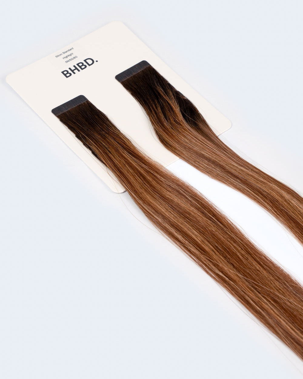 BHBD Tape Extensions 5N/5G/8G – pre-taped Remy human hair extensions in blended brown and golden blonde shades; seamless, soft and tangle-free; comes in 35cm, 50cm, and 60cm. 100% Remy hair, gentle extensions.