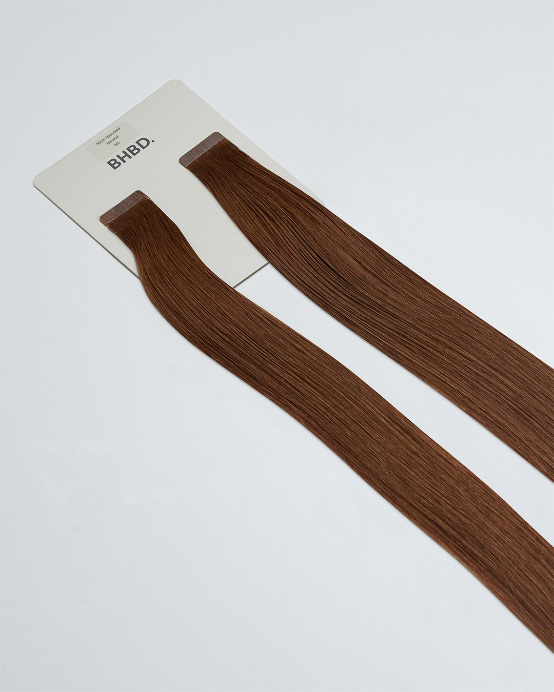 Tape Extensions 6G – pre-taped Remy human hair extensions in golden medium brown shade; seamless, soft and tangle-free; comes in 35cm, 50cm, and 60cm. 100% Remy hair, gentle extensions.