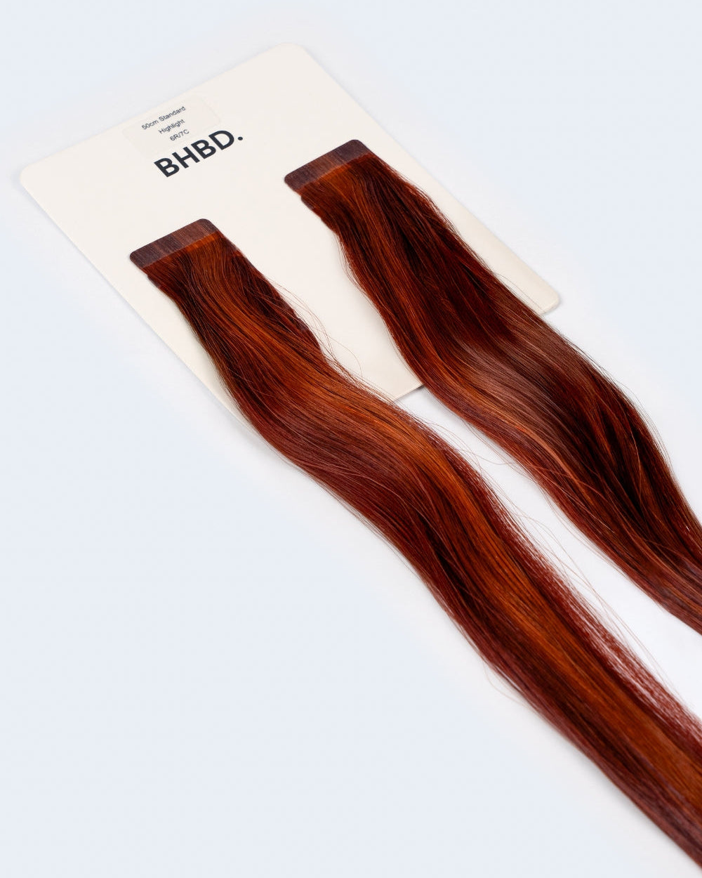 BHBD Tape Extensions 6R/7C – pre-taped Remy human hair extensions in warm copper and auburn tones; seamless, soft and tangle-free; comes in 35cm, 50cm, and 60cm. 100% Remy hair, gentle extensions.