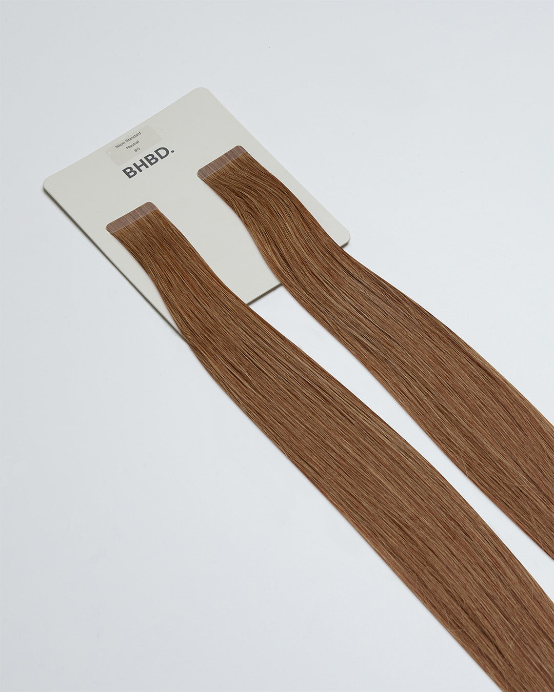 Tape Extensions 8G – pre-taped Remy human hair extensions in medium golden blonde shade; seamless, soft and tangle-free; comes in 35cm, 50cm, and 60cm. 100% Remy hair, gentle extensions.