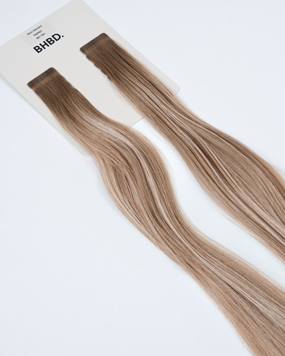BHBD Tape Extensions 9B/11BA Highlight – pre-taped Remy human hair extensions in ash blonde and beige highlights; seamless, soft and tangle-free; comes in 35cm, 50cm, and 60cm. 100% Remy hair, gentle extensions.