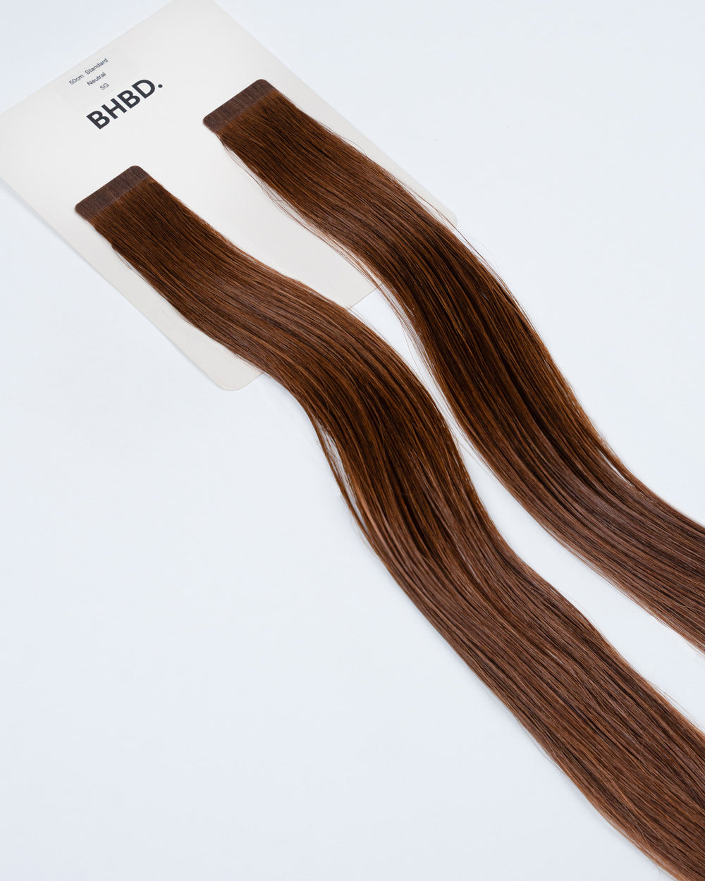 BHBD Tape Extensions 5G – pre-taped Remy human hair extensions in golden brown shade; seamless, soft and tangle-free; comes in 35cm, 50cm, and 60cm. 100% Remy hair, gentle extensions.