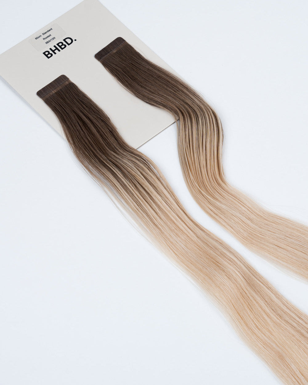 BHBD Tape Extensions 9BA/12N Rooted – pre-taped Remy human hair extensions with darker roots blending into soft blonde lengths; seamless, soft and tangle-free; comes in 35cm, 50cm, and 60cm. 100% Remy hair, gentle extensions.