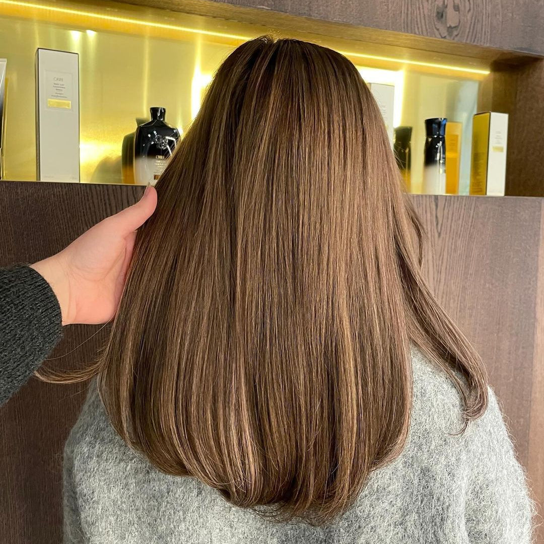 Brown-haired woman with 35cm long BHBD hair extensions.