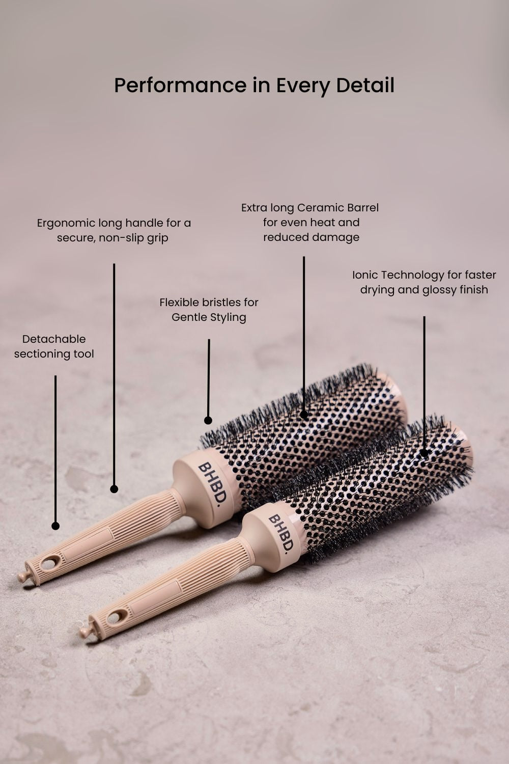 BHBD round brushes placed on a neutral surface, highlighting their ergonomic long handles, detachable sectioning tools, ceramic barrels, flexible bristles, and ionic technology for professional styling and reduced frizz.