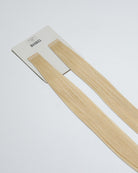Tape Extensions 11N – pre-taped Remy human hair extensions in a light natural blonde shade; seamless, soft and tangle-free; comes in 35cm, 50cm, and 60cm. 100% Remy hair, gentle extensions.