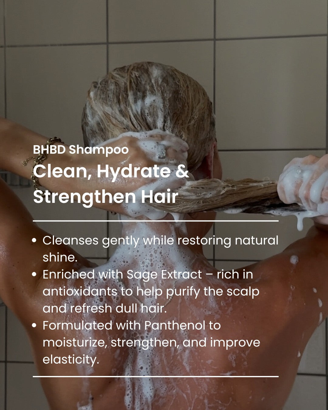 Person washing hair with BHBD shampoo, showing product use in a bathroom setting.
