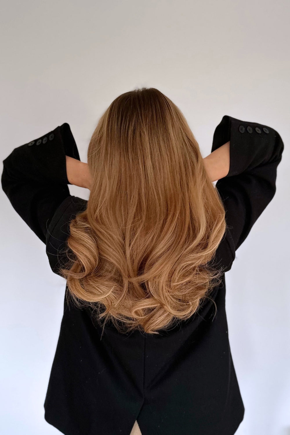 Model showing voluminous curls styled with BHBD Heatless Curls silk curler. No heat, gentle overnight styling.