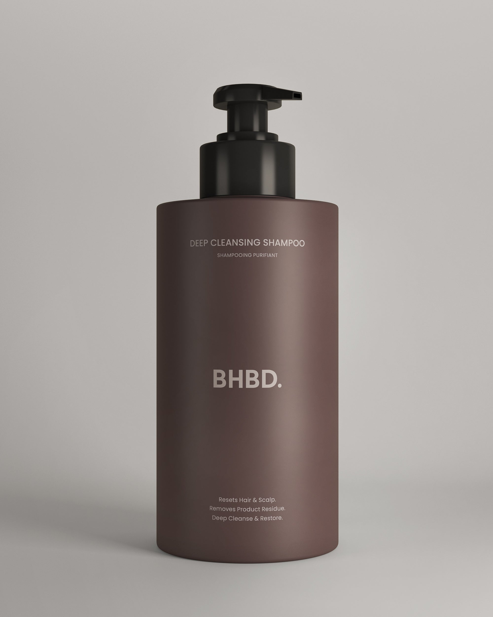 Brown shampoo bottle with black pump labeled 'BHBD' on a beige background. BHBD Deep Cleansing Shampoo.