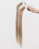 Tape Extensions 9BA – pre-taped Remy human hair extensions in light ash blonde shade; seamless, soft and tangle-free; comes in 35cm, 50cm, and 60cm. 100% Remy hair, gentle extensions.