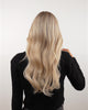 Blond woman removing a BHBD hairband extensions showing with extensions and without from the back and front