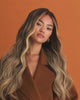 Video of Balayage Wig 50 cm in brown and blonde blend with soft waves and HD lace front, showing natural movement and texture on model.