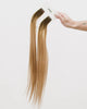 Tape Extensions 4N/8N – pre-taped Remy human hair extensions in dark brown blended with medium natural blonde; seamless, soft and tangle-free; comes in 35cm, 50cm, and 60cm. 100% Remy hair, gentle extensions.
