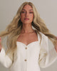 Video of Scarlet Wig 50 cm natural blonde HD lace human hair wig with dark blonde roots and subtle lowlights, showing natural shine and scalp effect on model.